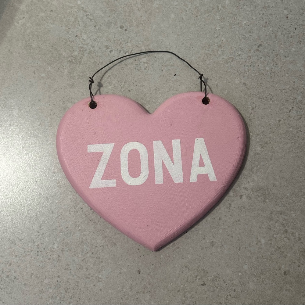 Pink Heart-Shaped “ZONA” Hanging Sign